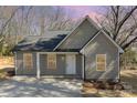 Charming one-story home featuring a neutral color, inviting front porch, and a well-maintained concrete driveway at 290 Houston Ne St, Concord, NC 28025