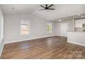 Bright living room features hardwood floors, ceiling fan and abundant natural light from the large windows at 290 Houston Ne St, Concord, NC 28025