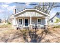 Inviting home showcasing a classic porch with seating and curb appeal at 308 W Charlotte Ave, Mount Holly, NC 28120