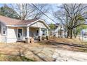 Quaint home with a cozy porch and attractive landscaping at 308 W Charlotte Ave, Mount Holly, NC 28120