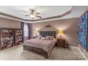 Serene main bedroom featuring a tray ceiling, plush carpeting, and ample natural light at 3090 Tallgrass Blf, Rock Hill, SC 29732