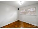 Bright bedroom with hardwood floors, light walls, and natural light from the window at 3501 Winterfield Pl, Charlotte, NC 28205