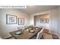 Modern dining room features a large table set for six with neutral decor and stylish artwork at 443 Zender Ln, Monroe, NC 28112