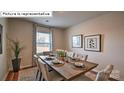 Modern dining room features a large table set for six with neutral decor and stylish artwork at 443 Zender Ln, Monroe, NC 28112