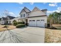 Charming two-story home with a two-car garage, landscaped yard, and inviting front porch at 5006 Sand Trap Ct # 142, Monroe, NC 28112