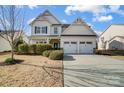 Charming two-story home with a two-car garage, landscaped yard, and inviting front porch at 5006 Sand Trap Ct # 142, Monroe, NC 28112