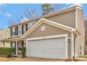 Home's two car garage featuring clean white doors and beige siding to match the exterior at 733 Rocky Grove Gln, York, SC 29745