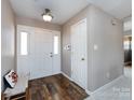 Inviting foyer with beautiful wood flooring, a hall closet, and neutral wall paint at 7936 Rolling Stone Ave, Charlotte, NC 28216