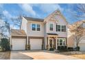 Charming two-story home with a three-car garage, well-maintained landscaping, and inviting front porch at 8028 Tricia Pointe Pl, Indian Land, SC 29707