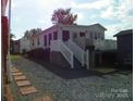 Exterior of home with a shed, a deck, stairs and an easy access lift at 111 Scenic Ln, New London, NC 28127