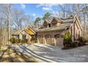 Beautiful home boasts a three-car garage, stone and brick exterior, and a spacious driveway for easy parking at 11280 Mcfalls Dr, Fort Mill, SC 29707