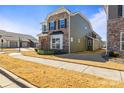 Charming two-story home with a stone and siding exterior, landscaped yard, and sidewalk at 13203 Caite Ridge Rd, Davidson, NC 28036