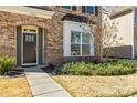 Charming home featuring a stone facade, arched doorway and tidy landscaping at 13203 Caite Ridge Rd, Davidson, NC 28036
