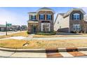 Two-story home with a stone and green siding exterior, a well-manicured lawn, and classic curb appeal at 13203 Caite Ridge Rd, Davidson, NC 28036
