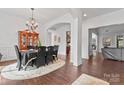 Spacious dining room with hardwood floors, elegant chandelier, and seamless flow to other living areas at 1485 Sierra Rd, York, SC 29745