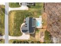 Aerial view of a home featuring a private backyard with a pool, a well-maintained lawn, and mature trees at 150 Canopy Oak Ln, Statesville, NC 28625