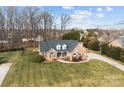 Charming brick home featuring a manicured lawn, complemented by mature trees and inviting curb appeal at 150 Canopy Oak Ln, Statesville, NC 28625