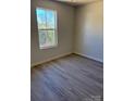 Bright bedroom with modern floors and natural light from the window at 195 Bethesda Rd, Statesville, NC 28625
