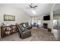 Cozy living room with vaulted ceiling, skylight, fireplace, and comfortable seating at 204 Edinburgh Ct, Mount Holly, NC 28120