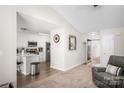 Open-concept view of living room and kitchen with hardwood floors and modern appliances at 204 Edinburgh Ct, Mount Holly, NC 28120