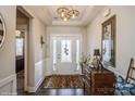 Bright foyer with hardwood floors, decorative light fixtures, and white trim at 2112 Balting Glass Dr, Indian Trail, NC 28079