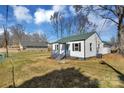 View of the charming home with light colored siding, blue door, green roof, and inviting front porch at 2123 Ravendale St, Kannapolis, NC 28083