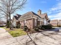 Brick home with stone chimney and manicured landscaping on a sunny day at 2670 Bellasera Way, Matthews, NC 28105