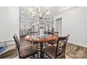 Open dining area with stylish chandelier and seamless flow to kitchen and living room at 27467 Cinderella Cir, Lancaster, SC 29720