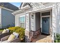 Inviting front porch featuring cozy seating and a stylish front door with decorative wreath at 27467 Cinderella Cir, Lancaster, SC 29720