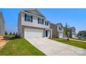 View of a modern two-story home featuring a two-car garage and landscaped front yard in a suburban area at 3060 Ora Smith Rd, Lincolnton, NC 28092