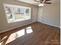 Bright living room featuring hardwood floors, natural light, and a large bay window at 3460 Hickory Pl, Salisbury, NC 28144