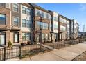 Modern townhome exterior featuring brick and siding, complemented by a wrought iron fence at 3729 S Tryon St, Charlotte, NC 28217