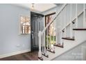 Inviting entryway with hardwood floors, staircase, and a front door welcoming natural light at 4151 Ivystone Ct, Charlotte, NC 28277