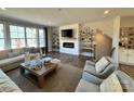 Inviting living room features a modern fireplace with stylish shelving, comfortable seating, and large windows for natural light at 4387 Reed Creek Dr, Sherrills Ford, NC 28673