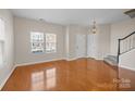 Spacious living room featuring hardwood floors, two entry doors and a staircase at 604 Atherton Way, Rock Hill, SC 29730