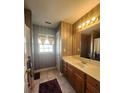 Traditional bathroom featuring wood vanity with white countertops and a large mirror at 7135 Tabor Falls Dr, Harrisburg, NC 28075