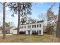 Inviting traditional home with a two-car garage, dormer windows, and a pristine white exterior at 7201 Brassy Creek Ln, Charlotte, NC 28269