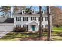 The home's exterior features dormer windows, black shutters, and an inviting turquoise-painted front door at 7201 Brassy Creek Ln, Charlotte, NC 28269