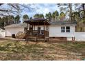 Spacious backyard with a wooden gazebo, deck, and white picket fence at 781 Niblick Dr, Gastonia, NC 28054