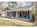 Inviting front porch with black columns, seating, and decorative accents at 781 Niblick Dr, Gastonia, NC 28054