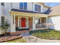 Inviting front porch with brick accents and a vibrant red door creating a warm welcome at 8802 Glenside St, Huntersville, NC 28078