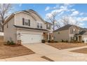 Two-story home featuring a two-car garage, brick and siding accents, a welcoming entrance, and neatly maintained landscaping at 920 Clementine Rd, Monroe, NC 28110