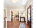 Elegant foyer with hardwood floors, table, and a view into the office space at 11309 Brittany Oaks Dr, Charlotte, NC 28277