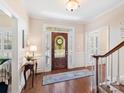 Inviting foyer with hardwood floors, staircase, and a front door with sidelights at 11309 Brittany Oaks Dr, Charlotte, NC 28277