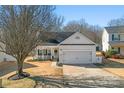 Charming single-Gathering home with a front porch, manicured lawn, and a two-car garage at 117 Peterborough Dr, Mooresville, NC 28115