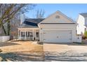 Charming single-Gathering home with a front porch, manicured lawn, and a two-car garage at 117 Peterborough Dr, Mooresville, NC 28115