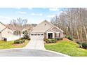 Landscaped front yard with a well maintained lawn and decorative shrubs, in front of a stone and siding single-Gathering home at 1209 Waypoint Ct, Matthews, NC 28104