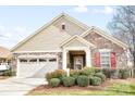 Charming single-Gathering home featuring a stone and siding exterior with a well-manicured front yard at 1209 Waypoint Ct, Matthews, NC 28104