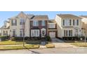 Attractive townhome with well-maintained landscaping, brick accents, and inviting front entrance at 14622 Greenpoint Ln, Huntersville, NC 28078