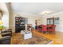 Open-concept living and dining area showcasing hardwood floors and comfortable seating arrangements at 14622 Greenpoint Ln, Huntersville, NC 28078
